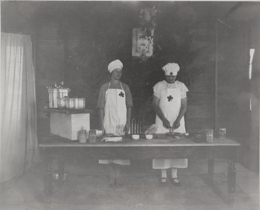 Girls Club members (now known as 4-H) demonstrate a canning processmost likely in the 1920s.