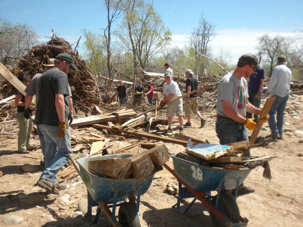 Volunteers help load up debris at the Western Mobile property near Hygiene