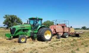 Tractor bailing hay