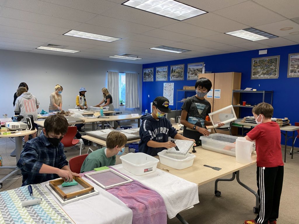 A class making the seed paper that will be planted