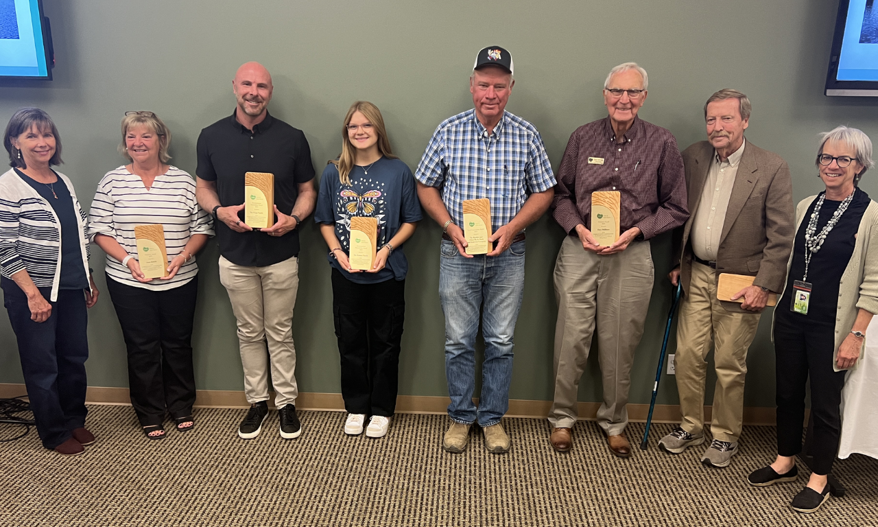 Award recipients holding their plaques. From left to right: Parks & Open Space Director Therese Glowacki, Anne Janicki, Brian Hepp, Emma Rooney, President of The Boulder and White Rock Ditch and Reservoir Company Jules Van Thuyne, Dave Millhiser, Keith Owen, and Commissioner Claire Levy