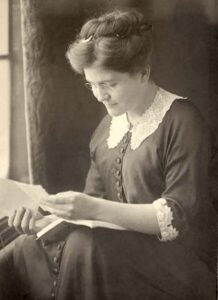 Josephine Roche with a book in her lap.