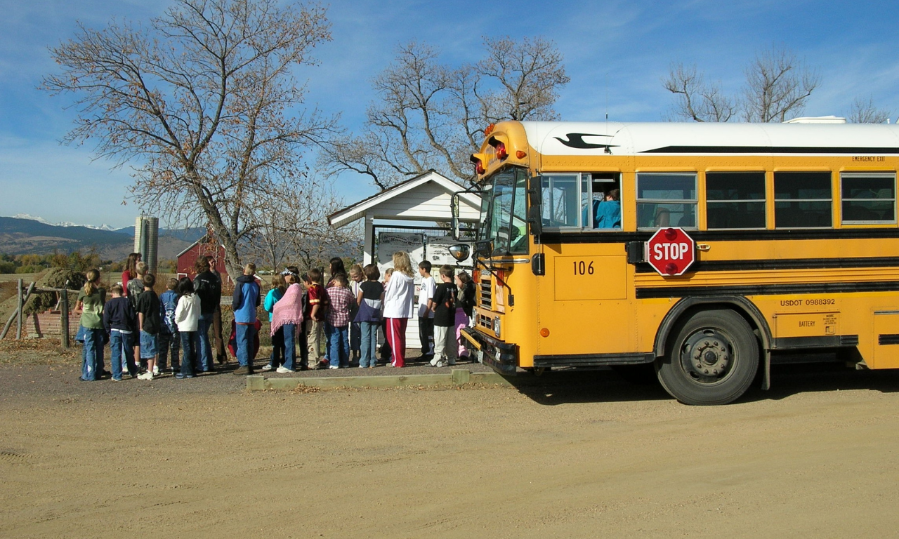 A school bus unloads students arriving for a field trip to explore the Agricultural Heritage Center.
