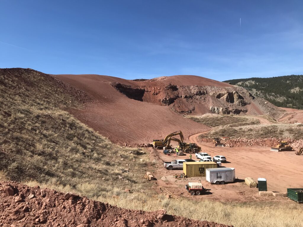 Construction equipment sits to the side of a newly reshaped hill